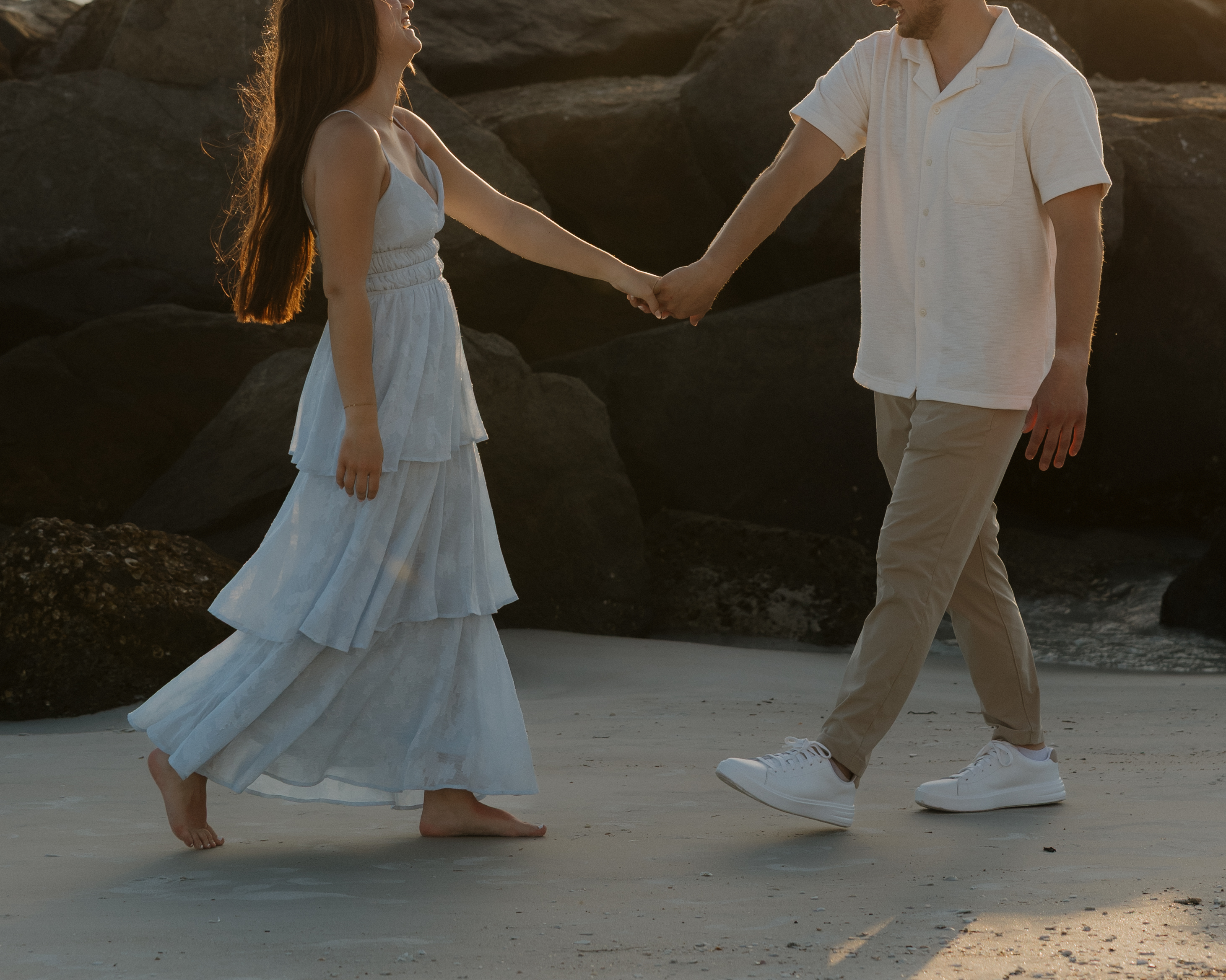 Alyssa and Caden holding hands by the water